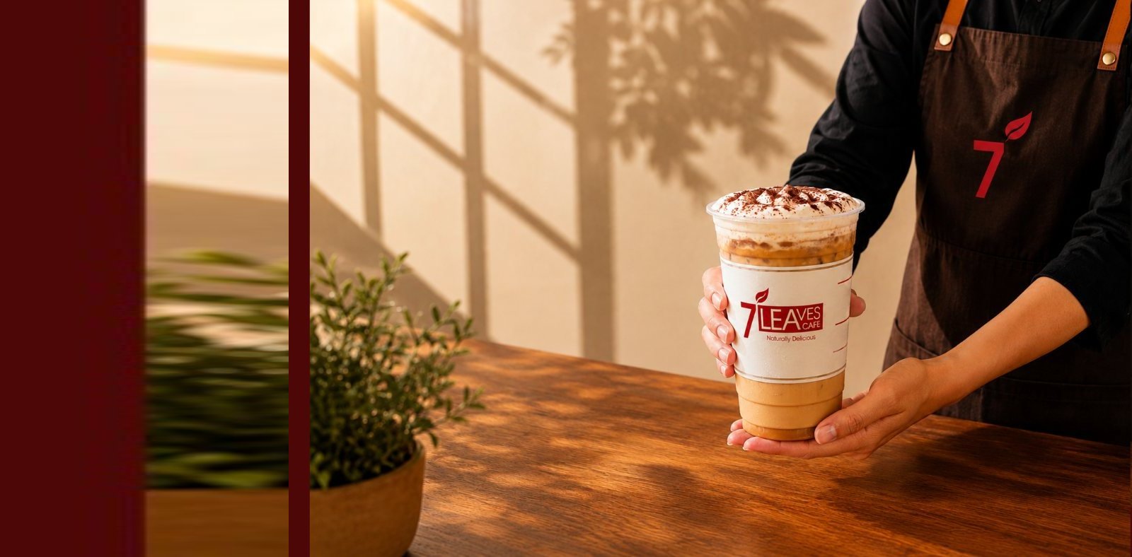 7 Leaves Cafe team members in front of the Drive Thru store