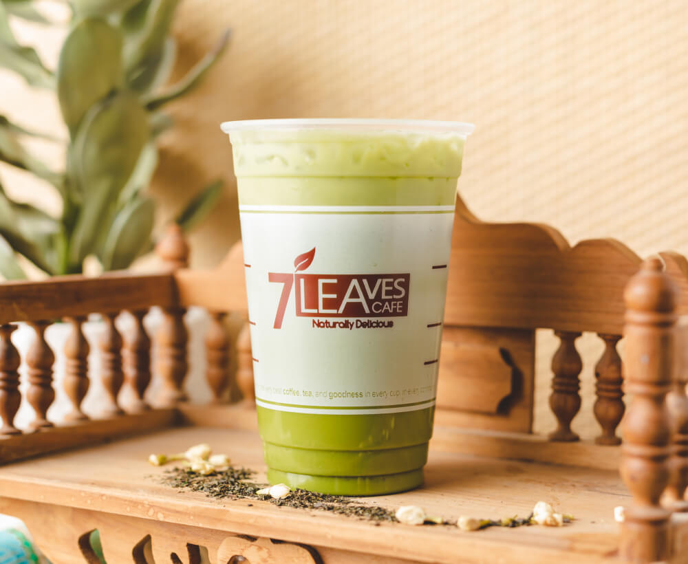 a photo of cold green thai tea drink in a cup