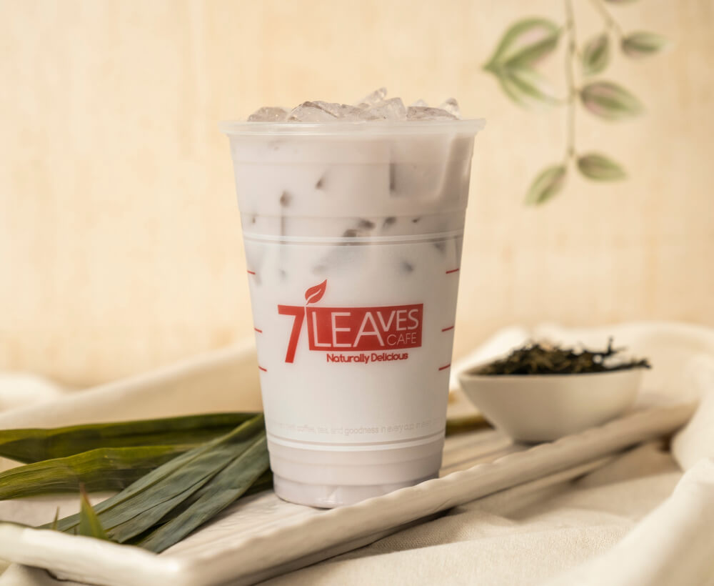a photo of cold taro milk tea drink in a cup